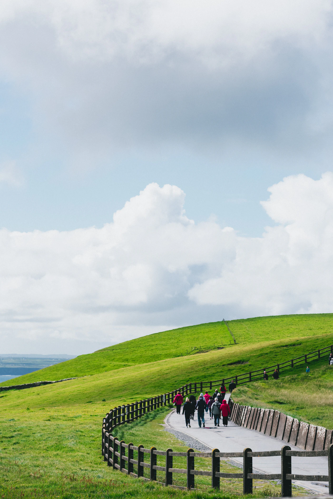 Small group walking across green countryside in Ireland