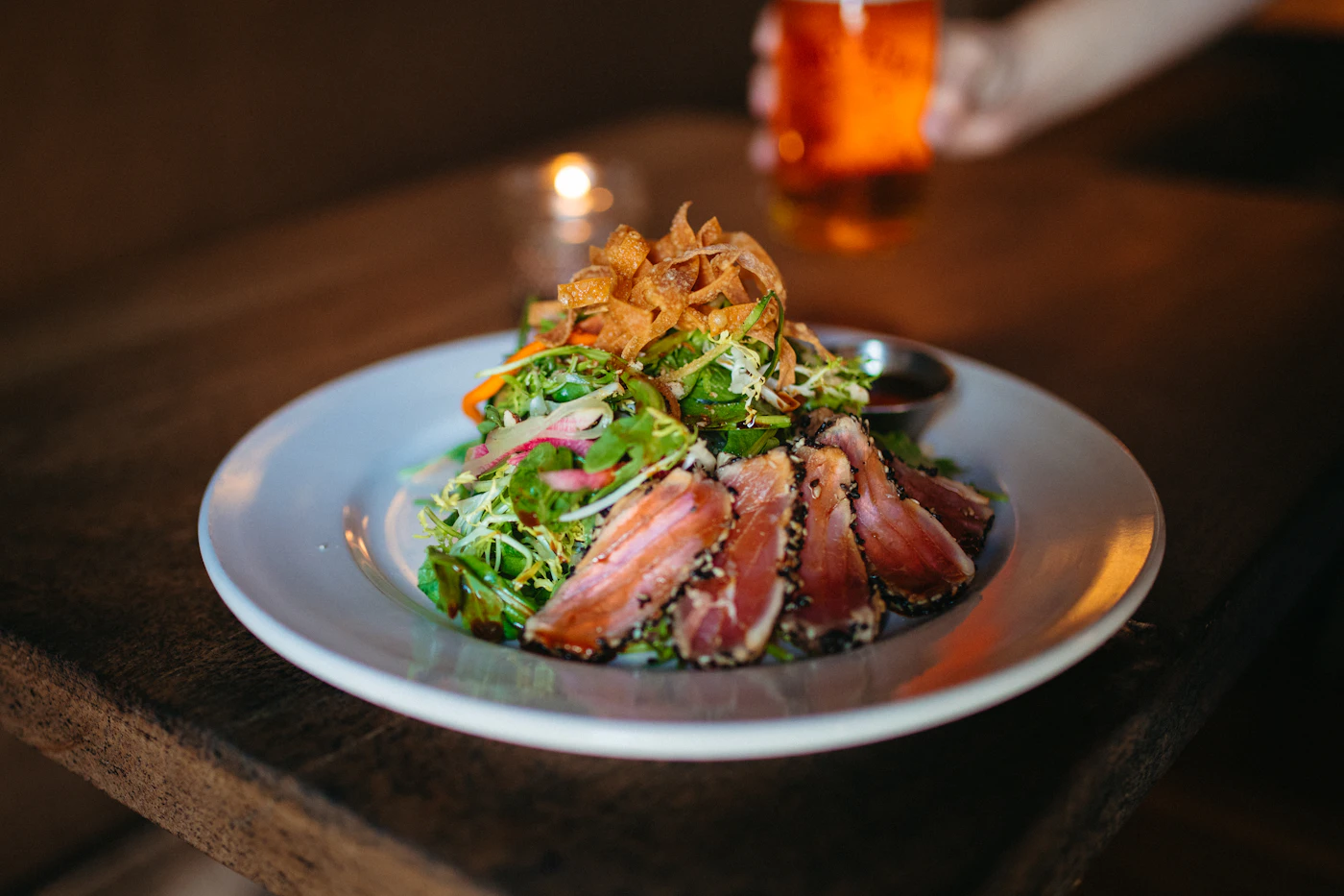 Restaurant meal served on a plate with salad and vegetables